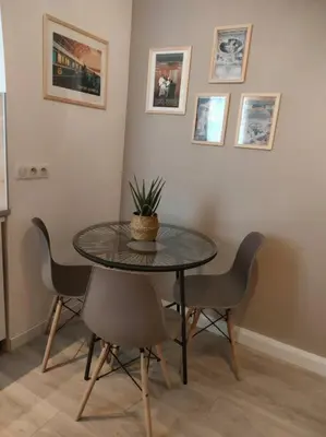 a table with chairs and a potted plant on it at «l’Orient Express» joli 2 pièces fonctionnel in Nice