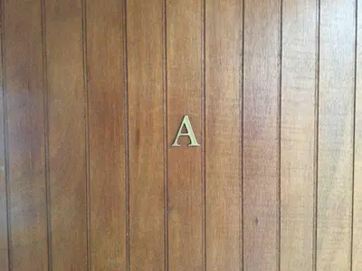 a sign on a wooden door with aphaltphaltphaltphaltphalt at Studio de charme au coeur de la vieille ville in Nice