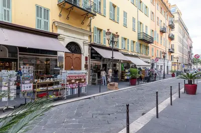 a street with shops and buildings in a city at MY CASA - MARI 71 - Unique Apt Near Sea in Nice