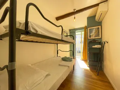 a room with two bunk beds and a hallway at Saint Francois de Paul - wifi, AC, 6 pers in Nice