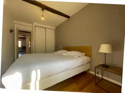 a bedroom with a large white bed and a lamp at Saint Francois de Paul - wifi, AC, 6 pers in Nice