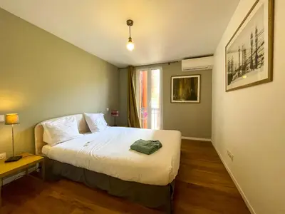a small bedroom with a bed and a window at Saint Francois de Paul - wifi, AC, 6 pers in Nice