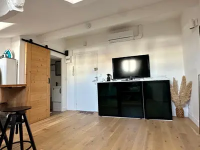 a living room with a flat screen tv on the wall at Beau studio au cœur de Nice in Nice