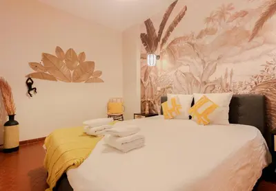 a bedroom with a large bed with a yellow blanket on it at Old Town Nice Place Rossetti Themed 2BR Apartment Full Air Conditioning in Nice