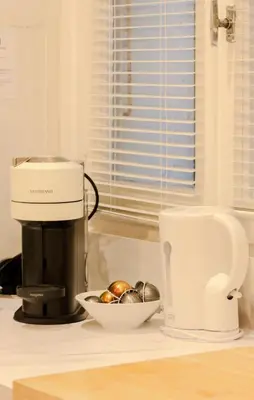 a coffee maker and a bowl of onions on a kitchen counter at Old Town Nice Place Rossetti Themed 2BR Apartment Full Air Conditioning in Nice