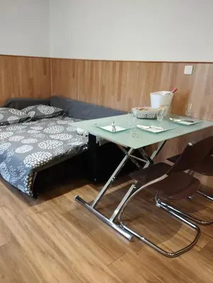 a table with two chairs next to a bed at Appartement 2 pièces rénover in Nice