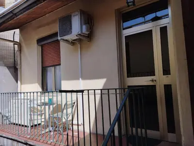 a balcony with a door and a table and a heater at Appartement 2 pièces rénover in Nice