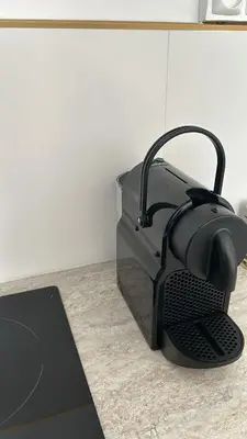a black iron sitting on top of a counter at Studio NICE CENTRE sur Avenue Jean Medecin MER à 8 minutes de marche in Nice