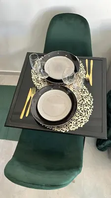 a black table with a plate and glasses on it at Studio NICE CENTRE sur Avenue Jean Medecin MER à 8 minutes de marche in Nice