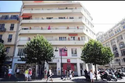 a large white building with people walking in front of it at Studio NICE CENTRE sur Avenue Jean Medecin MER à 8 minutes de marche in Nice