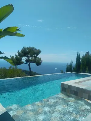 a swimming pool with a view of the ocean at Èze - Appartement dans bas de villa avec piscine près de Monaco in Èze