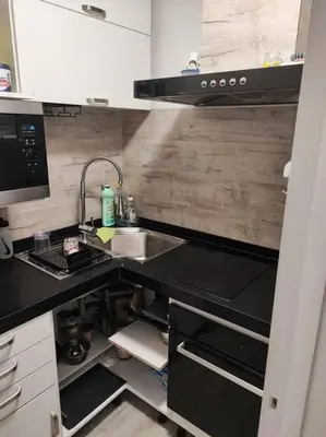 a small kitchen with a sink and a counter top at Studio 31 m² in Nice