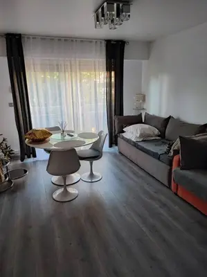 a living room with a table and a couch at Studio 31 m² in Nice