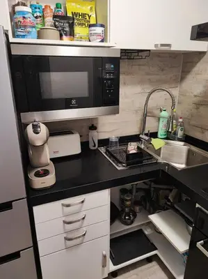 a kitchen with a sink and a microwave at Studio 31 m² in Nice