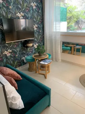 a living room with a couch and a flat screen tv at L'îlot Bornala in Nice
