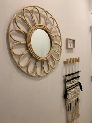 a gold mirror hanging on a wall with towels at L'îlot Bornala in Nice