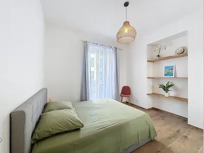 a bedroom with a bed and a pendant light at Le Francis - Riquier Port de Nice in Nice