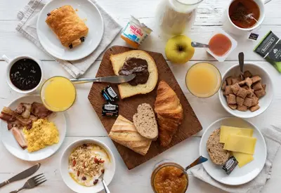 a table topped with plates of breakfast foods and drinks at B&B HOTEL Nice Stade Riviera in Nice