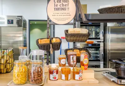 a counter with jars of food on a counter top at B&B HOTEL Nice Stade Riviera in Nice