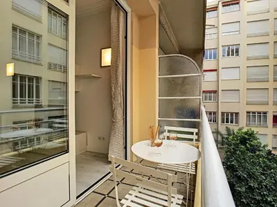 a balcony with a table and chairs and a window at Nestor&Jeeves - BEACH ROYAL - Central, Close sea in Nice