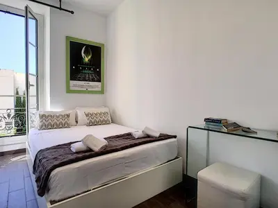 a white bedroom with a bed and a window at Nestor&Jeeves - DOLCE VITA MASTER - Jean Medecin in Nice