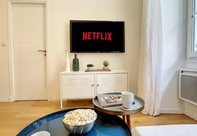 a living room with a tv on a wall at Nestor&Jeeves - COZY MACCARANI - City Center, Close sea in Nice