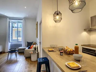 a kitchen with a counter top and a living room at Nestor&Jeeves - COZY MACCARANI - City Center, Close sea in Nice