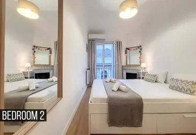 a bedroom with two beds and a mirror at Nestor&Jeeves - MADAGASCAR - 3 chambres, Centre-ville in Nice