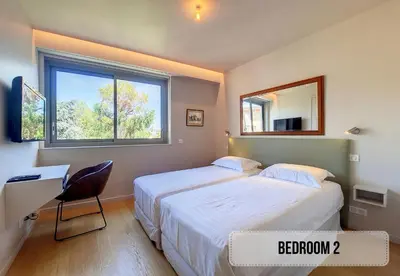 a bedroom with two beds and a desk and a mirror at Nestor&Jeeves - FLEURS TERRASSE - 3 chambres in Nice