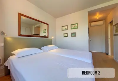 a large white bed in a bedroom with a mirror at Nestor&Jeeves - FLEURS TERRASSE - 3 chambres in Nice