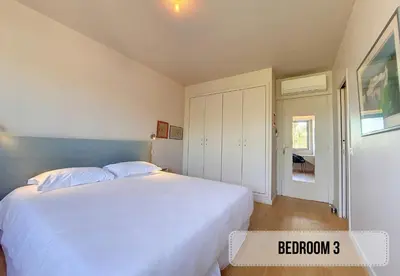a bedroom with a large white bed in a room at Nestor&Jeeves - FLEURS TERRASSE - 3 chambres in Nice