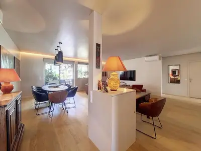 a kitchen and dining room with a table and chairs at Nestor&Jeeves - FLEURS TERRASSE - 3 chambres in Nice