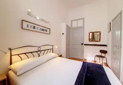 a bedroom with a large white bed and a chair at Nestor&Jeeves - TERRACOTTA - Premium location, close sea in Nice