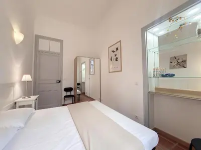 a bedroom with a white bed and a window at Nestor&Jeeves - TERRACOTTA - Premium location, close sea in Nice