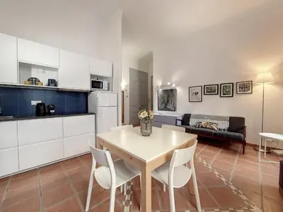 a kitchen and living room with a table and chairs at Nestor&Jeeves - TERRACOTTA - Premium location, close sea in Nice