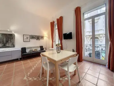 a living room with a table and a couch at Nestor&Jeeves - TERRACOTTA - Premium location, close sea in Nice