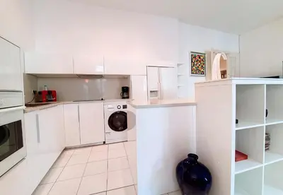 a white kitchen with a washer and dryer at Nestor&Jeeves - FRENCHY - Hyper center, Closer sea and Place Massena in Nice