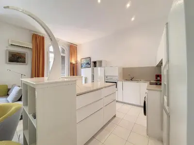 a kitchen with white cabinets and a white refrigerator at Nestor&Jeeves - FRENCHY - Hyper center, Closer sea and Place Massena in Nice