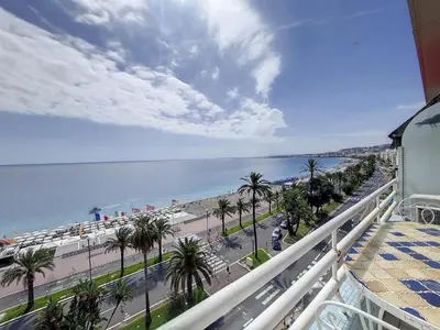 a balcony with a view of a beach and the ocean at Nestor&Jeeves - MEDITERRANEE PROMENADE - Vue Mer in Nice