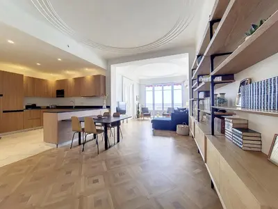 a kitchen and living room with a table and chairs at Nestor&Jeeves - MEDITERRANEE PROMENADE - Vue Mer in Nice