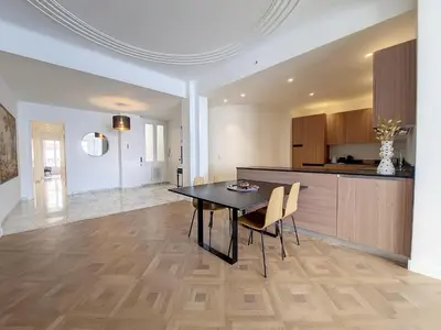 a kitchen and dining room with a table and chairs at Nestor&Jeeves - MEDITERRANEE PROMENADE - Vue Mer in Nice