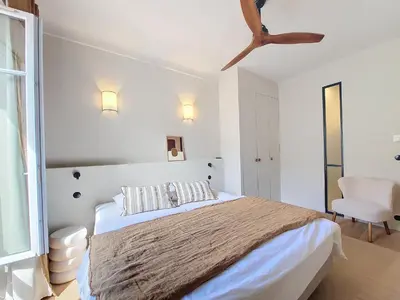 a white bedroom with a bed and a chair at Nestor&Jeeves - RIVIERA - Central - Near Beach in Nice