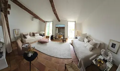 a living room with a couch and a table at Charmant deux pièces dans le quartier du Port in Nice