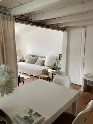 a living room with a white couch and a table at Charmant deux pièces dans le quartier du Port in Nice