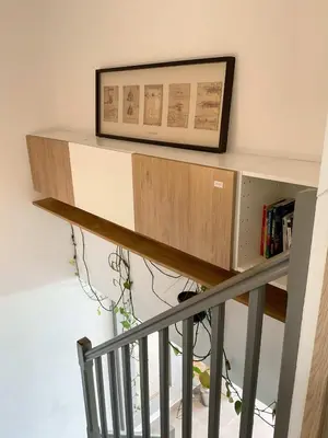 a staircase with a shelf and a picture on the wall at La Prom 2 - a two bedroom apartment with a sea view in Nice