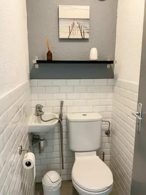 a bathroom with a toilet and a sink at La Prom 2 - a two bedroom apartment with a sea view in Nice