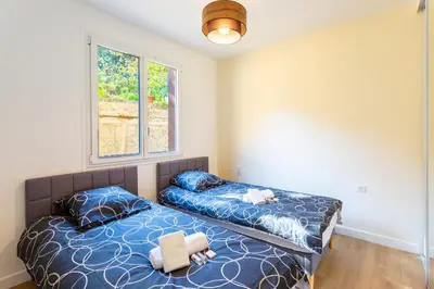 a bedroom with two beds and two windows at LE MONT ALBAN AP4360 By Riviera Holiday Homes in Villefranche-sur-Mer