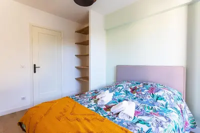 a bedroom with a bed with a colorful comforter at LE MONT ALBAN AP4360 By Riviera Holiday Homes in Villefranche-sur-Mer