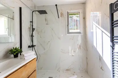 a white bathroom with a shower and a tub at LE MONT ALBAN AP4360 By Riviera Holiday Homes in Villefranche-sur-Mer