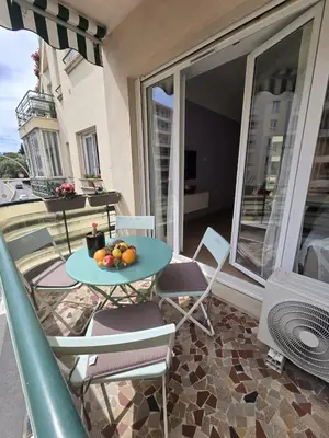 a balcony with a table with fruit on it at Gloria apartments in Nice